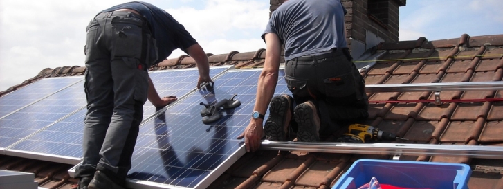2 people installing a solar panel