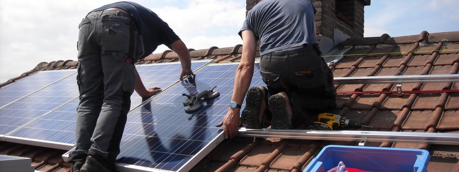 2 people installing a solar panel